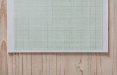 graph paper with square background,close up blank graph paper on wooden desk with copy space for textの写真素材