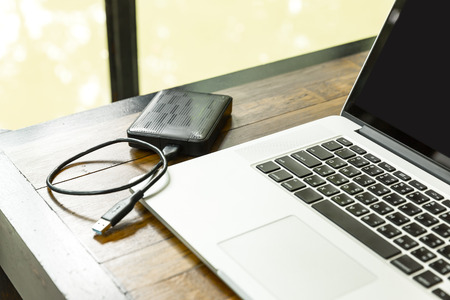 portable hard drive and laptop computer, External hard disk and laptop computer, with selective focusの写真素材