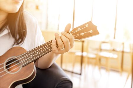 Close up of woman playing ukulele- music conceptの写真素材