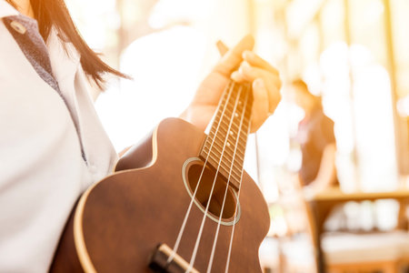 woman handicraft playing ukulele - selective focus,copy space for advising, Selective focus