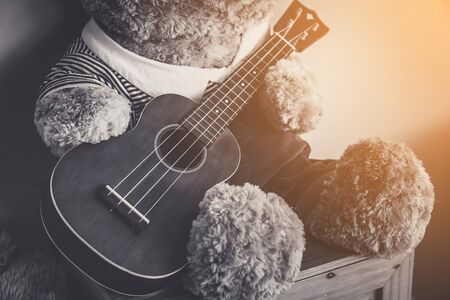 Teddy bear playing guitar, vintage style - Selective focusの写真素材