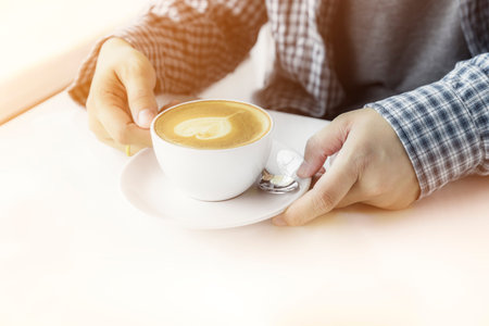 woman hand with cup of coffee, with heart shape - drinks and people conceptの写真素材