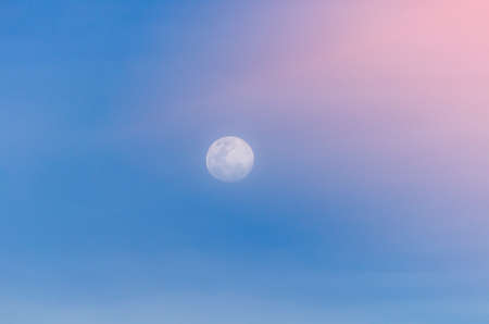 background of blue sky with the moonの写真素材