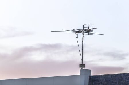 Digital TV aerial or antenna on top of a houseの写真素材
