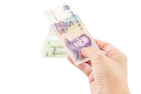 hand holding chinese banknote on white background - 5 yuanの写真素材