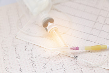 Medical plastic intravenous system on ECG or EKG (electrocardiogram)chartの写真素材