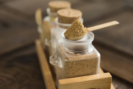 brown sugar in wood spoon on sugar containerの写真素材