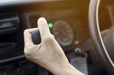 woman driving a car with hand handle gear stick - vintage filterの写真素材