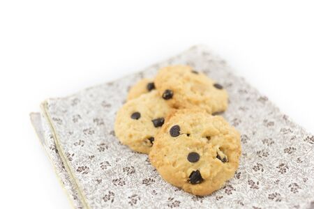 Chocolate chip cookies on linen napkin on white background - selective focusの写真素材