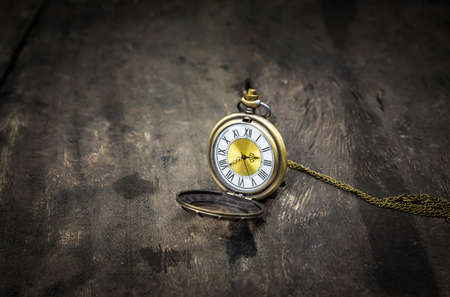 Still life with vintage pocket watch on grunge wooden background - from above : vintage styleの写真素材