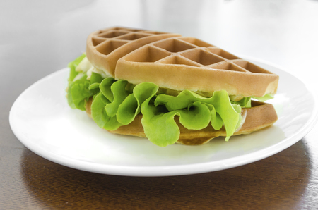 waffle sandwich with cheese on a white ceramic plate - vegetarian food conceptの写真素材