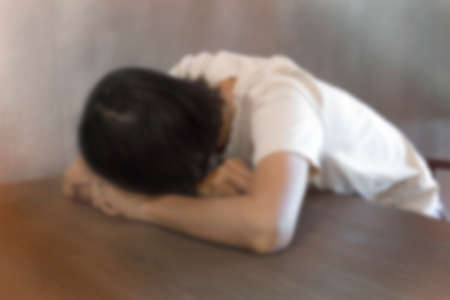 blurred image of sad woman alone in a room - sad conceptの写真素材