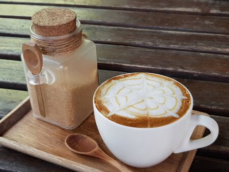 cup of cappuccino, cup of coffee on brown wooden tableの写真素材