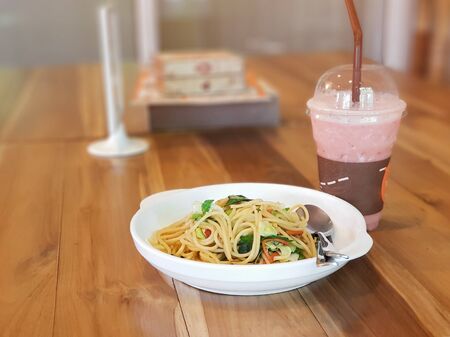 Thai style spaghetti with spices on wooden table in restaurant - Vegetarian Foodの写真素材