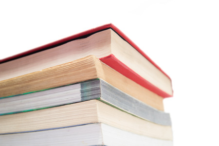 Stack of used books isolated on a white backdropの写真素材