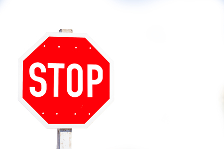 Red octagon shape stop sign on white background wit copy-spaceの写真素材