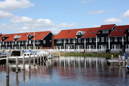 Pier houses and boats at the port Reitdiep in Groningenの写真素材