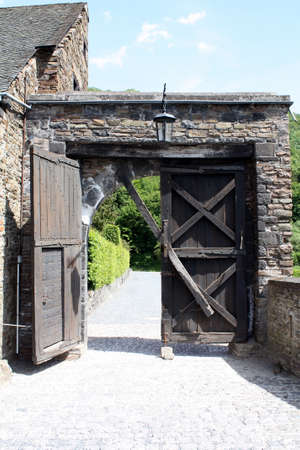 Old wooden castle door is open.の写真素材