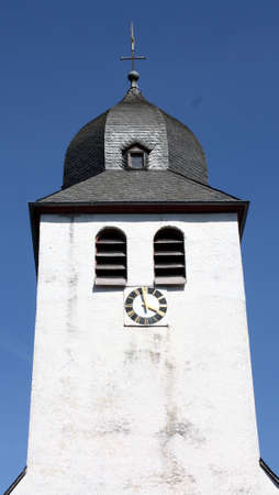 Church Tower of the Pfarrkirche St. Nicholas against a blue sky in Mayen. Germanyの写真素材