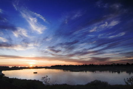 tall shot of carlsbad lagoon during sunset with oranges and bluesの写真素材