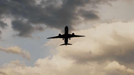 Passenger airplane taking off at sunset against the background of a very beautiful clouds.の写真素材