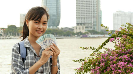 Vietnamese girl photographer takes pictures of nature in the city center at sunsetの写真素材