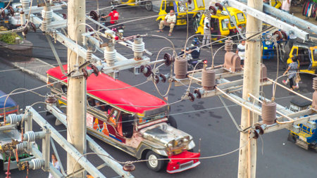 Power lines in the city. Transformers and phone lines against road in Filipino city.