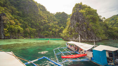 Coron, Philippines - January 5, 2018: Twin Lagoon in Coron, Palawan, Philippines. Mountain and Sea. Lonely Boat. Tour A.のeditorial素材