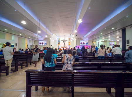 Dubai, UAE - May 15, 2018:: Catholic church during the service with people.. Christianity in Muslim...