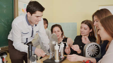 Students play with electroforming machine before the lesson of physics.の写真素材