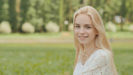 Close-up face of a smiling 19 year old blonde girl.の写真素材