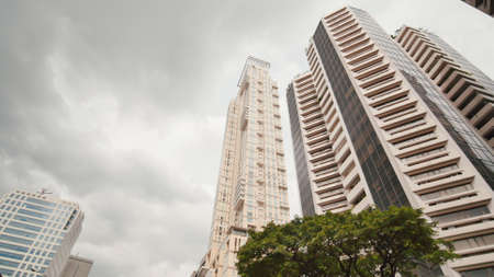 Skyscrapers against the backdrop of palm trees. Shooting in motion. Makati District in Manila. Philippines.の写真素材