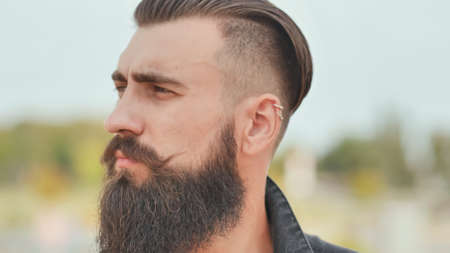 Portrait of a close-up of a brutal smiling and bearded man.の写真素材