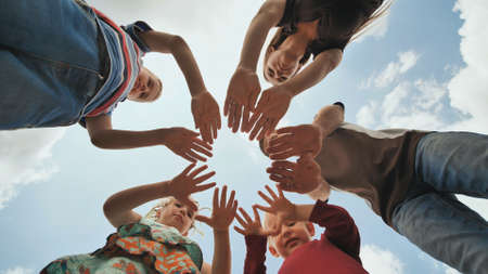 A young family of 6 connects the palms in a circle shape. The concept of a strong and friendly family.の写真素材