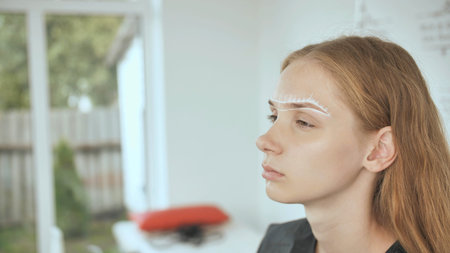 Create permanent eyebrow makeup. Marking the shape of the eyebrows.