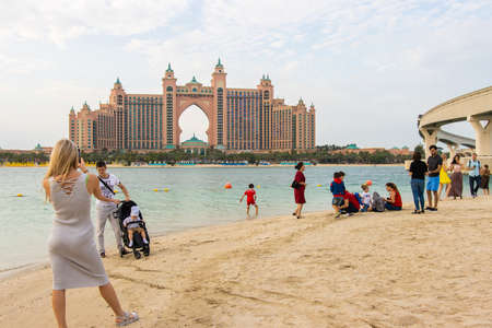 Dubai, UAE - December 14, 2019: Beach with tourists on the background of the Atlantis hotel.のeditorial素材