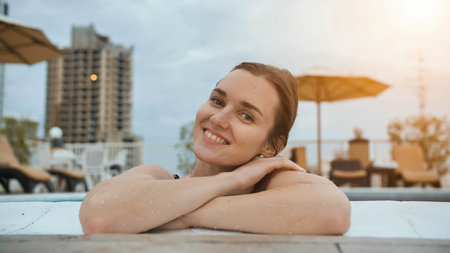 Girl after swimming posing in the pool.