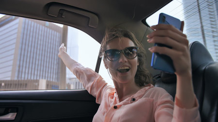 The girl is broadcasting live from a car using a phone from Dubai.