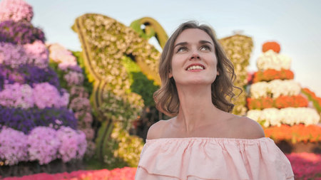 A girl walks through a beautiful fairytale park in Dubai.