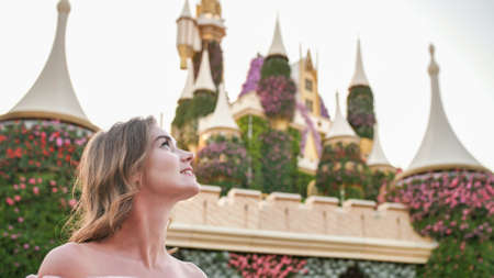 A girl walks through a beautiful fairytale park in Dubai.の写真素材