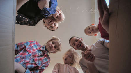 A large family opens the box in their home.の写真素材