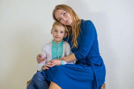 Happy young mother with her son in national Russian clothes.の写真素材