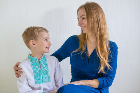 Happy young mother with her son in national Russian clothes.の写真素材