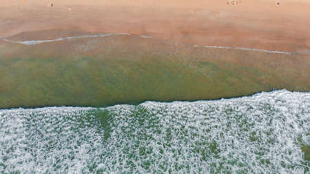 Aerial drone view of deserted Arambol beach on Goa with waves. India.の写真素材