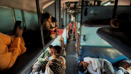 Agra, India - December 12, 2018: Indian train and economy class carriage inside with passengers.のeditorial素材
