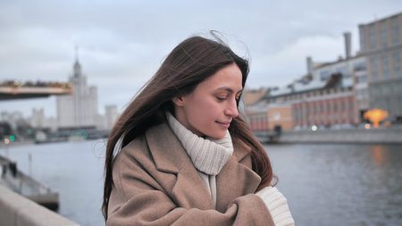 Sad girl freezes on the street Moscow. Person walking along the promenade. Mysterious girl walking...