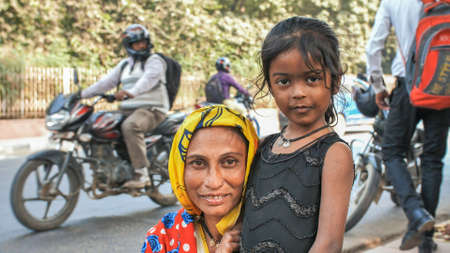 Agra, India - December 12, 2018: Portrait Indian mother and daughter on the streets of the city.のeditorial素材