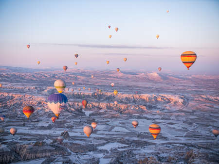 Goreme, Turkey - January 11, 2020: Colorful balloons over volcanic rocks in Cappadocia. Turkey.のeditorial素材