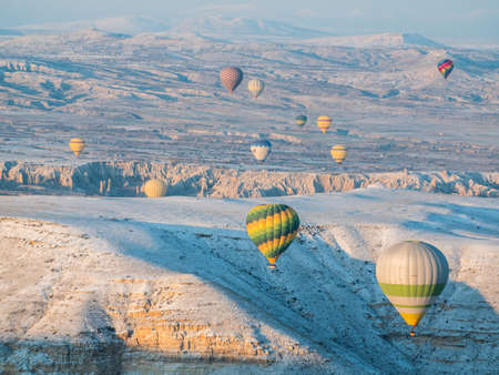 Goreme, Turkey - January 11, 2020: Colorful balloons over volcanic rocks in Cappadocia. Turkey.のeditorial素材