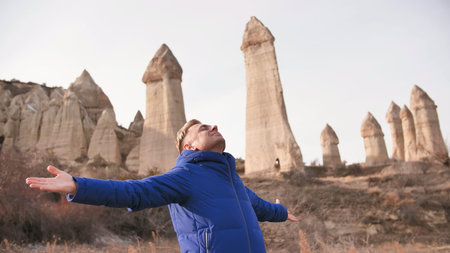 Russian tourist energized in the Valley of Love in Goreme Cappadocia Turkey during the freezing...